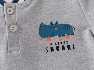 Macro shot of grey polo shirt with navy rhino print and A CRAZY SAFARI text detail