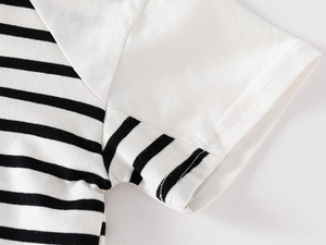 Detail of neatly stitched sleeve and armhole on a black and white striped cotton polo shirt