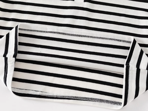 Detailed close-up showing neat double-needle stitching on the black and white striped hem