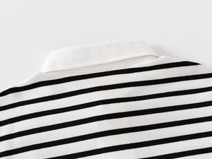 Close-up of classic black and white striped polo shirt with white collar and fine stitching