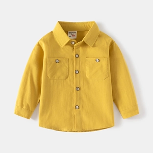 Front view of ginger yellow cotton shirt for kids with long sleeves and dual chest pockets