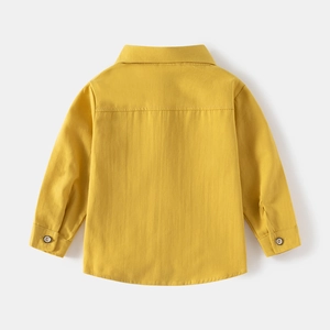 Detailed back view of children's yellow long-sleeved shirt with neat stitching and cotton texture