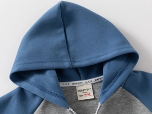 Detailed close-up of blue and gray hooded sweatshirt with resin zipper and brand label