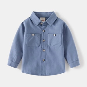 Detailed close-up of blue cotton kids long sleeve shirt with double chest pockets