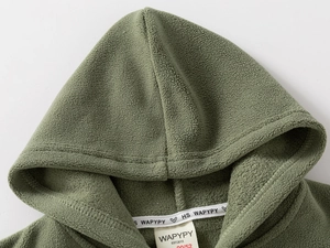 Detail of a green fleece hoodie showing the neck label and soft textured fabric