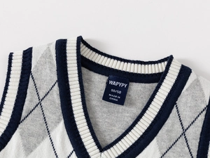 Macro detail of V-neck argyle knit vest with navy ribbing and high-quality stitching