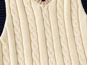 Detailed cable knit pattern on children's V-neck vest with navy ribbed trim accents