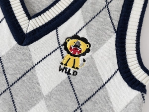 Detail of V-neck knitted vest with argyle pattern and wild lion embroidery
