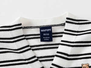 Detail of baby striped knit cardigan with embroidered bear and size label on the neckline