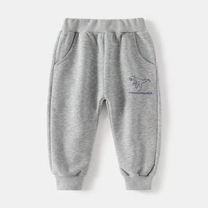 Detail of grey knitted boys' joggers featuring elastic waist and navy dinosaur print