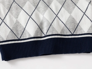 Close-up of boys argyle knit vest featuring classic diamond pattern and ribbed hem