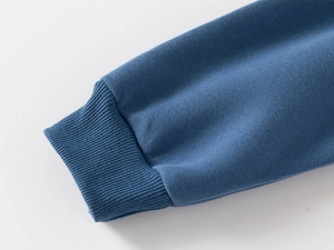 Close-up of ribbed cuffs on blue cotton hoodie showing high-quality stitching detail