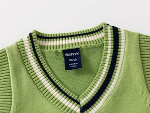 Detailed V-neck collar of green knit vest with classic blue and white striped ribbing