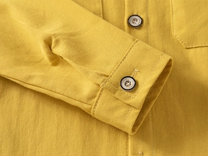 Macro shot of ginger cotton shirt cuff with classic buttons and fine stitching details