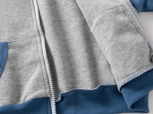 Detail of soft fleece lining and high-quality resin zipper on children's hooded sweatshirt