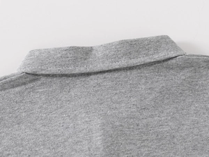 Close-up of grey polo neck with fine knitting texture and double-stitched seams