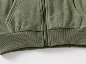 Detailed view of the olive green polar fleece hoodie with durable zipper and ribbed hem