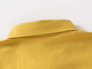 Close-up of ginger yellow cotton shirt collar featuring neat double-stitched flat seams