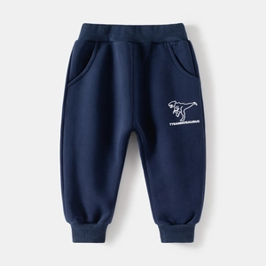 Detail of dark blue boys' sweatpants featuring a white dinosaur print and ribbed cuffs