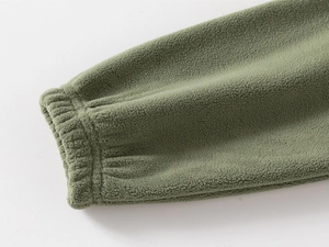 Close-up detail of green fleece jacket cuff with high-quality elastic wristband design