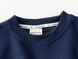 Detail of navy blue sweatshirt neckline featuring ribbed collar and WAPYPY brand label