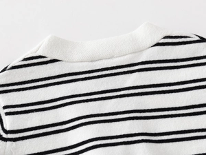 Close-up of the neck detail on this black and white striped knit sweater for boys