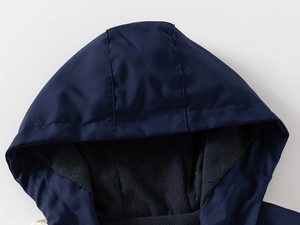 Détail de la veste à capuche bleu marine coupe-vent avec doublure polaire grise