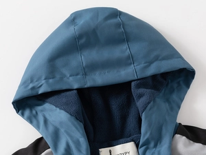 Detail view of the soft navy polar fleece lining and neck label inside the blue hooded jacket
