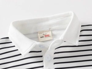 Close-up of a striped children's polo shirt collar with white buttons and brand label