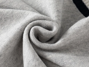 Macro shot of soft grey knit fabric showing detailed texture and thick stitching