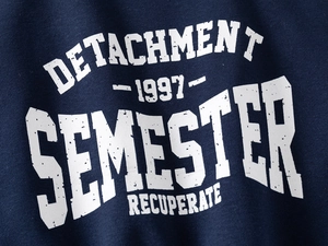 Close-up of vintage white lettering print on navy blue premium cotton sweatshirt fabric