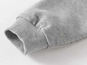Detail of grey ribbed cuffs on kids sweatshirt featuring high-quality cotton knit fabric