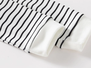 Close-up of black and white striped knit cuffs on a children's polo shirt