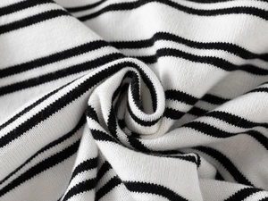 Close-up of soft black and white striped knitted fabric with fine machine weave texture