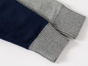 Macro detail of ribbed cuffs on navy blue and grey knit sweaters for kids' fashion