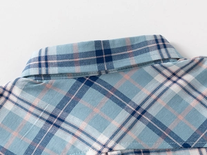Close-up of the light blue and pink plaid pattern on the classic point collar of a boy shirt