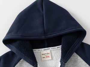 Detail view of thickened white fleece lining on a blue and grey hooded jacket