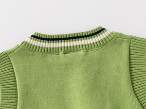 Detail of V-neck grass green knit vest with classic preppy style striped ribbing