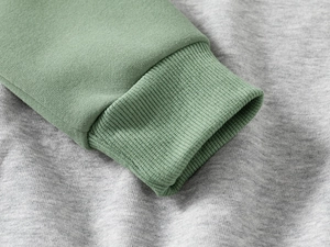 Close-up of ribbed cuffs on bean green and grey cotton dinosaur tracksuit set