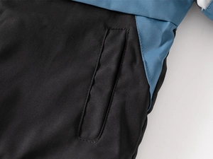Detailed view of durable stitching and vertical pocket on boys windproof outdoor jacket