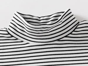 Macro detail of high neck collar and fine striped knit texture on children's top