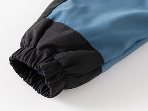 Detail of windproof sleeve cuffs with blue fleece lining and elastic stitching on jacket