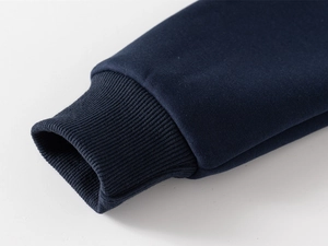 Detail of dark blue ribbed cuffs on a thick boy's hoodie with high-quality stitching