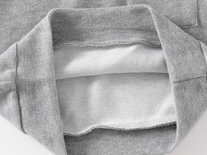 Close-up of ribbed hem and soft fleece lining on a gray children's sweatshirt