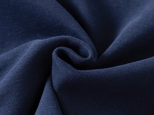 Close-up of premium navy blue knit fabric showing detailed fiber texture and softness