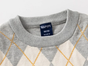 Detail of ribbed neckline and gray-yellow argyle pattern on kids knitted sweater