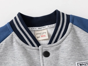 Detail of boys' baseball jacket collar with navy ribbed stripe and soft fleece lining