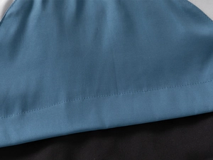 Macro view of blue and black fabric stitching on boys hooded jacket for winter wear