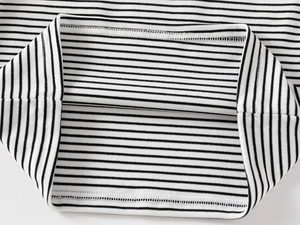 Detail of the black and white striped cuff and fine stitching on the thermal shirt