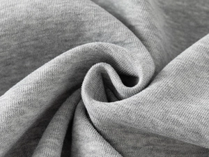 Close-up of premium grey knit fabric showing soft texture and high-quality cotton fibers